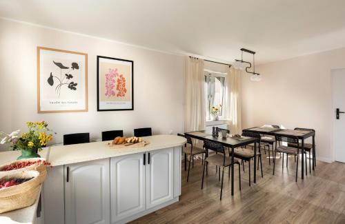 a kitchen and dining room with a table and chairs at Przystanek O2 in Smolniki