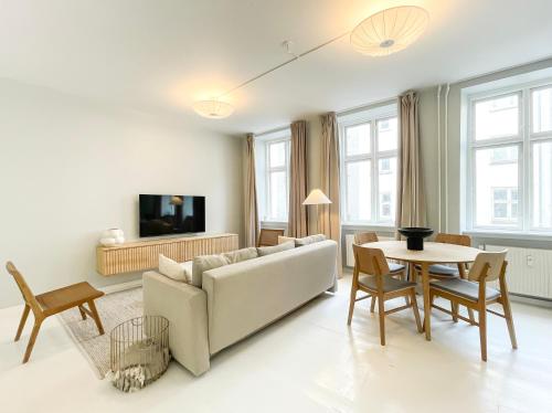 a living room with a couch and a table at Beautiful One-Bedroom Apartment in CPH City in Copenhagen