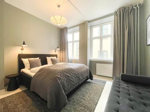 a bedroom with a bed and a large window at Beautiful One-Bedroom Apartment in CPH City in Copenhagen