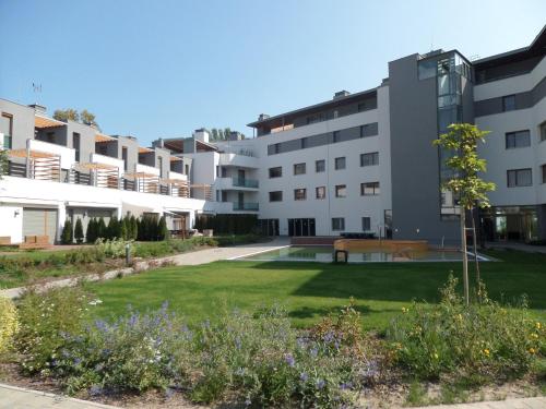 an apartment building with a park in the foreground at Silver DeLux Apartman in Balatonfüred