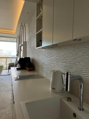a kitchen with a sink and a counter top at Seaside Park apartamenty prywatne z widokiem na morze in Kołobrzeg