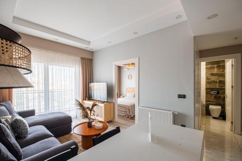 a living room with a couch and a table at Linkinn Luxury Residence & Spa in Esenyurt