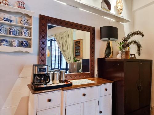 a room with a mirror and a counter with a coffee maker at Clocktower 2 Homestay 2-7 pax at Brinchang, Cameron Highlands in Cameron Highlands