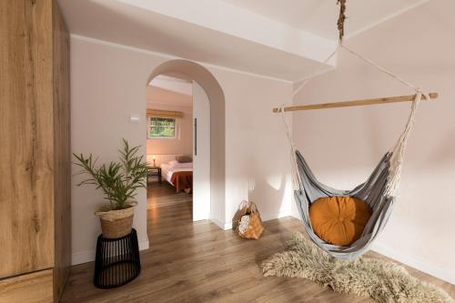 a room with a hammock hanging from the ceiling at Przystanek O2 in Smolniki