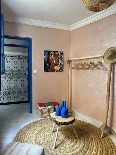 a room with a table with blue vases on it at Riad Fz Marrakech in Marrakech