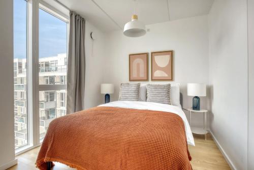 a bedroom with a bed and a large window at Amazing Two Bedroom Flat in Urban Area in Copenhagen