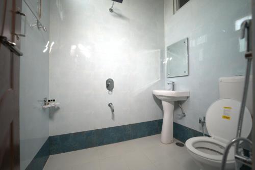 a bathroom with a toilet and a sink at Galactic inn in Srinagar