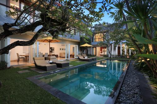 a swimming pool in the backyard of a house at Amadea Resort & Villas Seminyak Bali in Seminyak