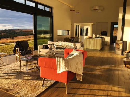 a living room with a couch and a table at Walkersons Estate- Outcrop in Dullstroom