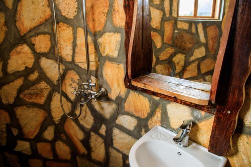 a bathroom with a sink and a window at Apuuli Safaris and Cottages in Kasusu
