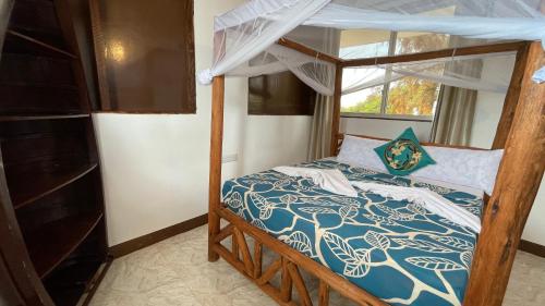 a bedroom with a bunk bed and a window at Aquarium Beach House in Nungwi