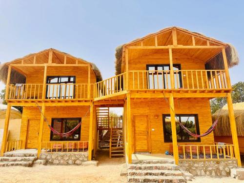 a large wooden house with two stories at Magic land taba camp in Taba