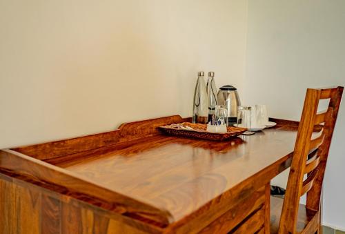 a wooden table with a counter top and a chair at Guldaar Sariska - A luxury Forest Resort in Tehla