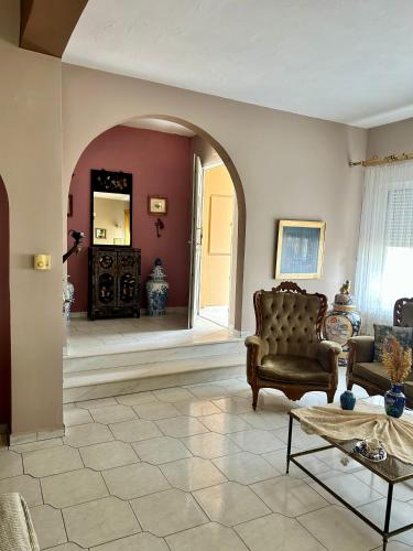 a living room with a couch and a table at Despina's House in Chrysoupolis