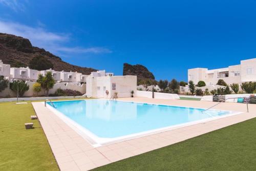 a large swimming pool in front of a villa at Casa Pizquito Agaete con piscina in Agaete