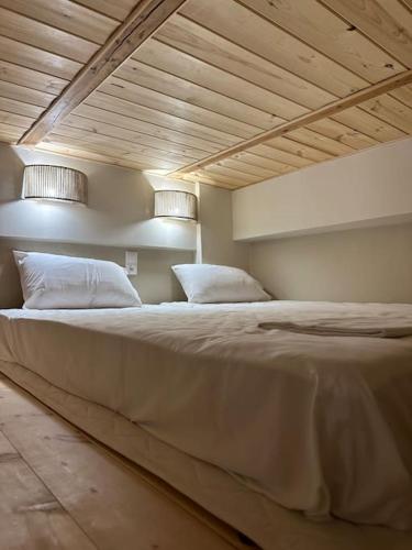 a large bed with two pillows in a room at Harma Apartment in Léntas