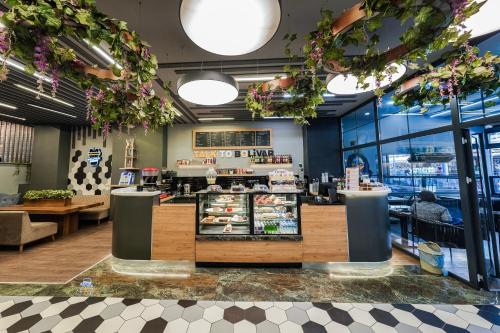 a restaurant with a counter with food on display at Konur Hotel in Ankara