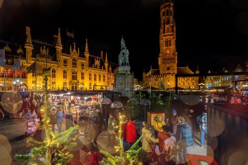 a group of people standing in front of a city at night at Mansion9Bruges in Bruges