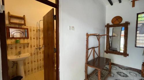 a bathroom with a sink and a mirror and a ladder at Aquarium Beach House in Nungwi