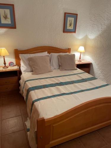 a bedroom with a large bed with two night stands at Olhao Apartment in Olhão