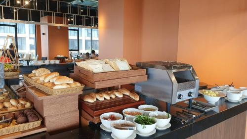 a bakery with bread and pastries on a counter at Apec Mandala Mui Ne by The Sea in Mui Ne