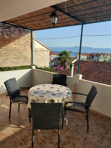 a patio with a table and chairs on a balcony at Apartments Beach Way in Trpanj
