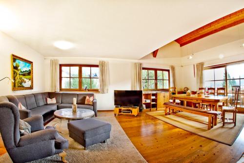 a living room with a couch and a table at ZugspitzApps, Apartement SCHÖNBLICK in Ehrwald