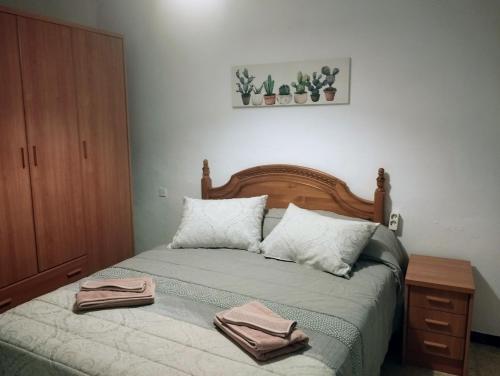 a bedroom with a bed with two towels on it at Casa Duque in Prado del Rey