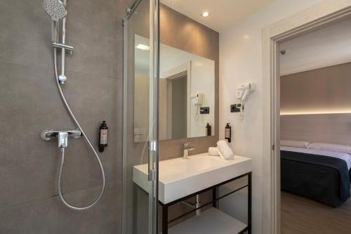 a bathroom with a sink and a shower at Porcel Ganivet in Madrid