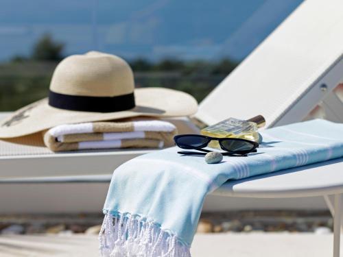 a hat and sunglasses are sitting on a boat at Lifestyle Hotel Vitar - Adults Only in Bol