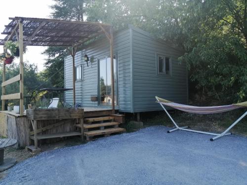 a hammock in front of a tiny house at Tiny house cosy in Anduze