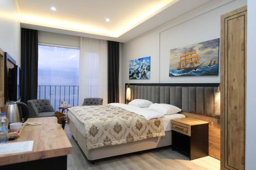 A bed or beds in a room at The Marine Hotel