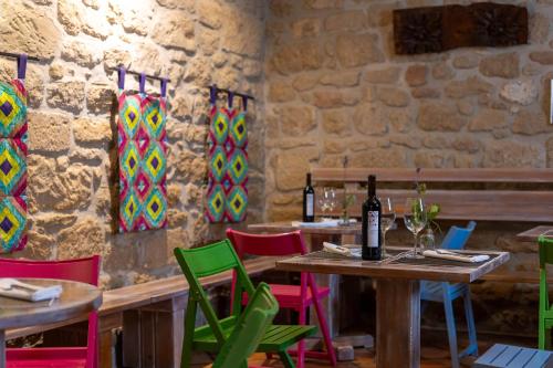 a dining room with tables and colorful chairs at Hotel Villa de Ábalos in Ábalos