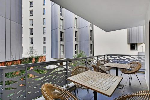 a balcony with a table and chairs on a building at Drawing House in Paris