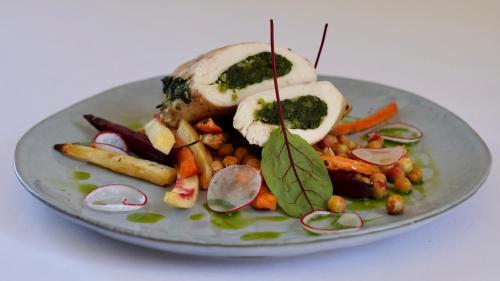 a plate of food with vegetables on a table at Gościniec Uniejów in Uniejow