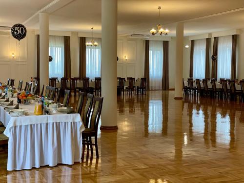 a banquet hall with tables and chairs in a room at Gościniec Uniejów in Uniejow
