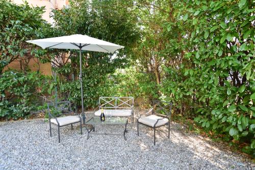 a table and two chairs and an umbrella at VILLARTE in Agliana