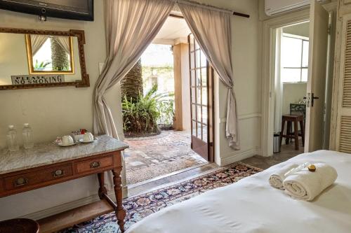 a bedroom with a bed and a door to a patio at Hidden Grace in Parys