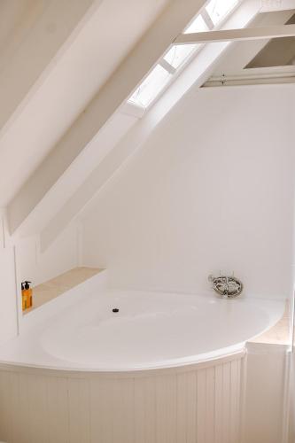 a white kitchen with a ceiling with skylights at 10i Mimosa by African Perfection in Jeffreys Bay