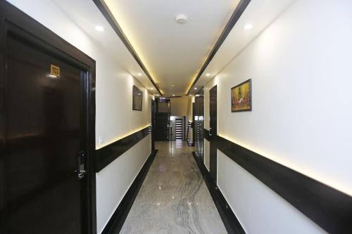 a corridor of a hallway with a door and a hallway at Collection O Hotel Pearl Blue in Tājganj