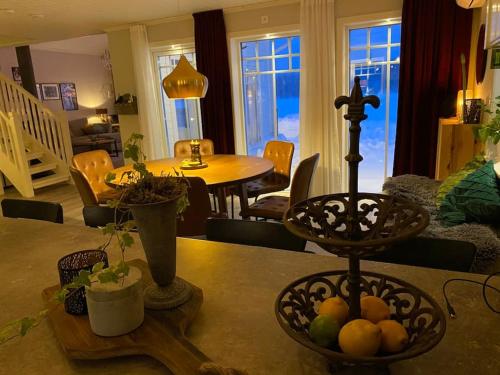 a table with a bowl of fruit on top of it at Northern Lights exclusive house by the river in Boden