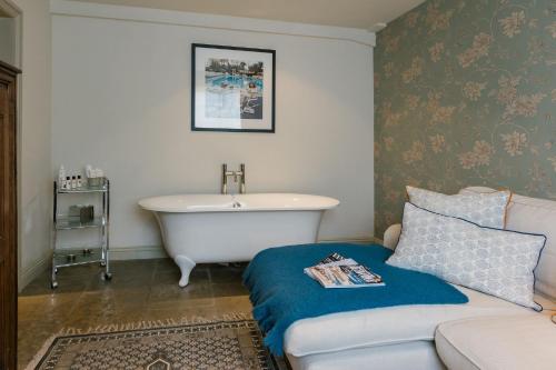 a living room with a bath tub and a couch at The White Swan Inn in Pickering