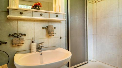 a white sink in a bathroom with a shower at Schluchseeoase in Schluchsee