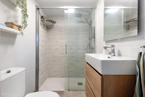 a bathroom with a shower and a toilet and a sink at El apretadero in Icod de los Vinos