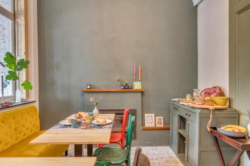 a dining room with a table and a table and chairs at La Dominotte Arcen in Arcen