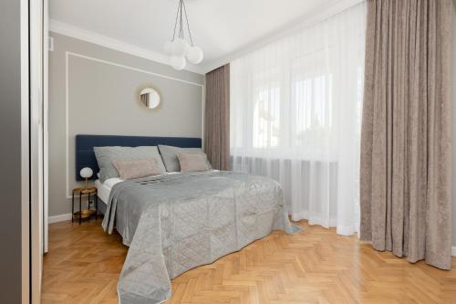 a bedroom with a bed and a large window at Apartment in the Centre of Warsaw by Renters in Warsaw