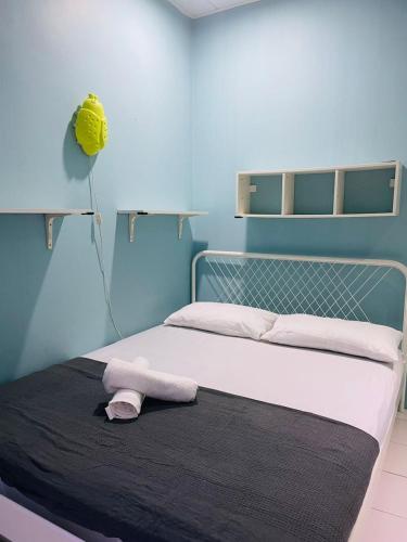 a bedroom with a bed with a towel on it at FREE Wi-fi 100mbps I Emerald Cove Rawang in Rawang