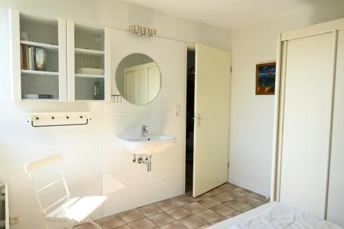 een badkamer met een wastafel en een spiegel bij Vakantiehuis Joossesweg in Westkapelle