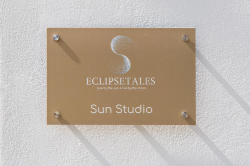 a sign on a wall that reads sun studio at Eclipse Tales in Adamas