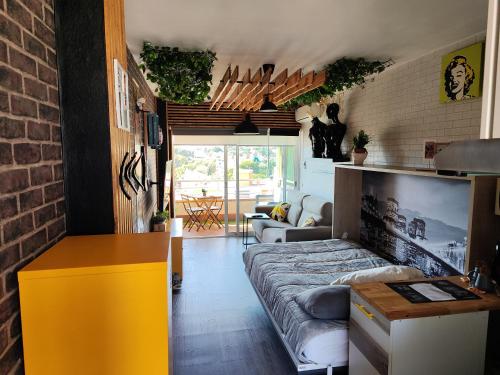 a living room with a couch and a table in a room at Saltillo Alto Boutique Studio in Torremolinos
